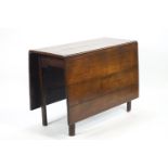 A plain rectangular elm wood gateleg table,