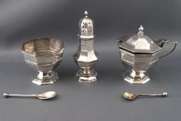 A silver three piece condiment set, of octagonal form, consisting of an open salt on pedestal foot,