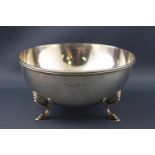 A Hemi spherical silver sugar bowl with applied bead edge raised on three decorated cabriole legs,