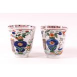 A pair of Chinese export porcelain Kangxi period wine cups(1654-1722) with later Dutch decoration
