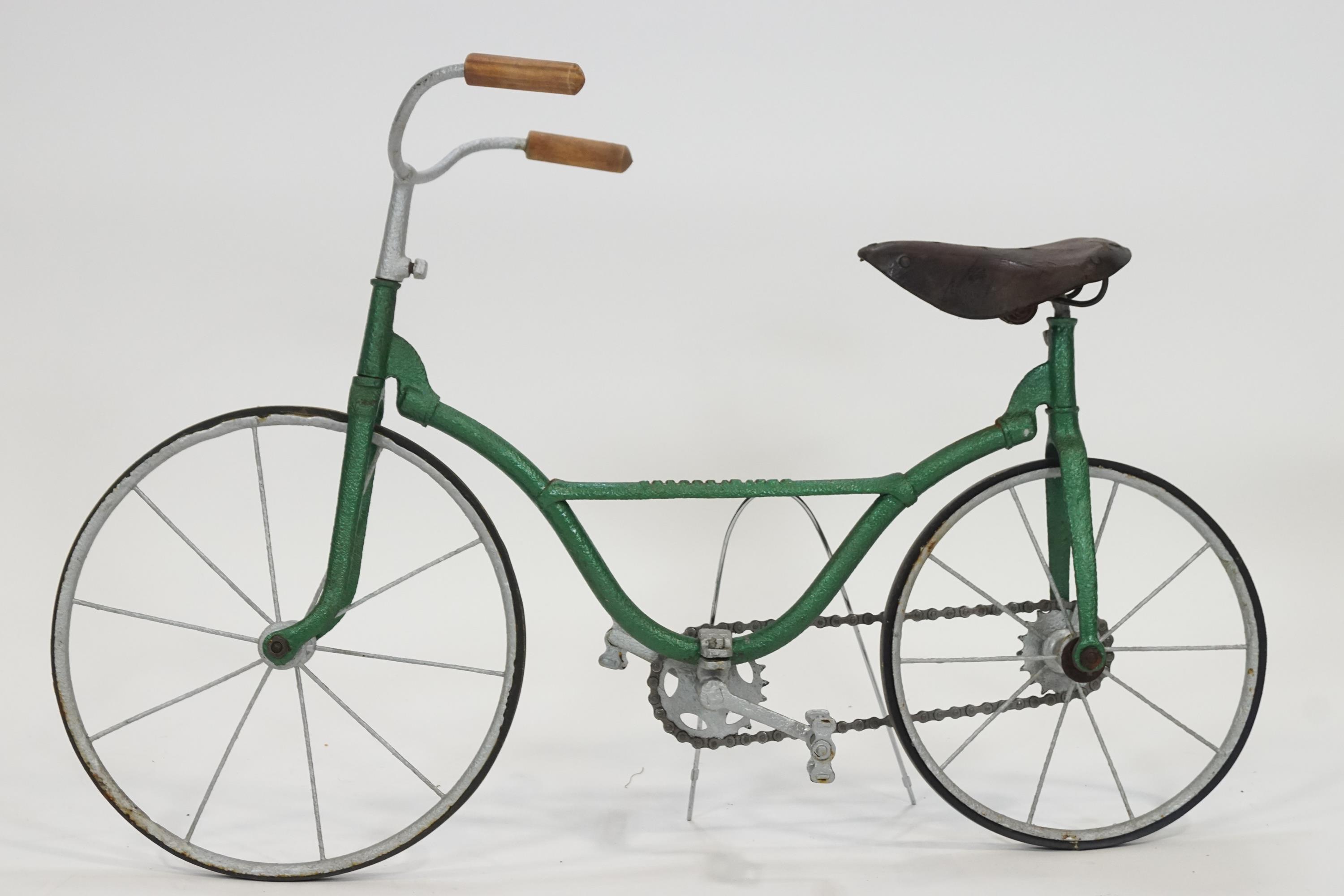 A miniature form bicycle frame with solid tyres 62cm high X 94cm wide