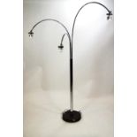 A chrome finished floor lamp with three moveable arch arms
