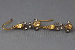 A yellow and white metal pair of drop earrings each set with oval faceted cut citrines and ....