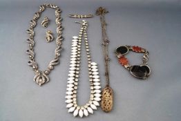 A collection of base metal costume jewellery to include three necklace, one bracelet....