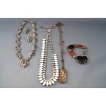 A collection of base metal costume jewellery to include three necklace, one bracelet....