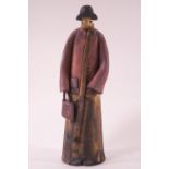 An earthenware of a lady in a red coat, by Howard Charles Masham,