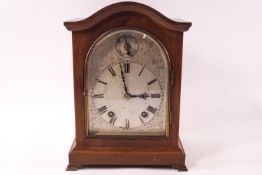 A W & H mahogany cased eight day mantel clock, the arched dial with fast/slow dial,