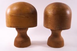 A pair of milliners hat stands, stamped 21 and 22, each on turned bases,