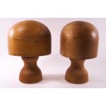 A pair of milliners hat stands, stamped 21 and 22, each on turned bases,