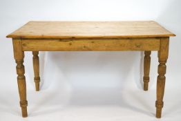 A Victorian pine rectangular kitchen table on turned legs with frieze drawer,