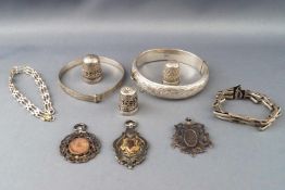 A selection of white metal jewellery items to include: Two bangles, a watch bracelet...