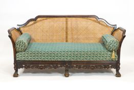 A sofa with mahogany frame carved and shaped in the William and Mary style