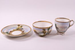 An early 19th century porcelain trio painted with landscapes....