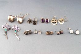 A collection of ten pairs of earrings of various styles