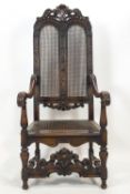 A carved hard wood elbow chair in the style of Daniel Marot,