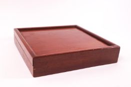 A mahogany cased travelling chess set of square form,