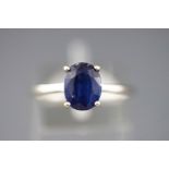 A white metal single stone ring set with an oval faceted cut Kyanite. Size P.