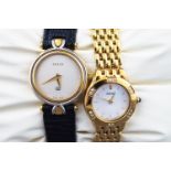 Two wristwatches : A steel and gold plate gucci watch with black leather strap....