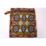 A 19th century bead work draw string purse with geometric patterns,