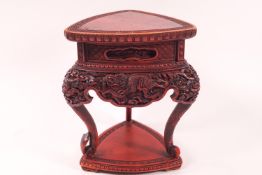 A cinnabar tripod stand carved with dragons,