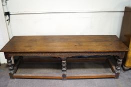 A large oak refectory table with four plank top on six turned legs linked by stretchers 82cm high x