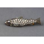 A yellow and white metal brooch stylized as a fish