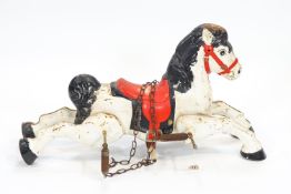 A 1950's/60's child's pressed metal painted toy horse, on four springs to be suspended on chains,