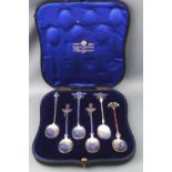 A cased set of six white metal Egyptian Revival enamelled tea spoons,