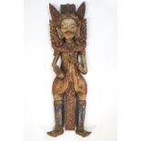 A carved wood and painted Indian figure with elaborate head dress, 78.5cm high