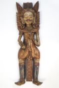 A carved wood and painted Indian figure with elaborate head dress, 78.5cm high