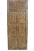 A pair of 19th century oak panels, each enclosing seven carved panels,