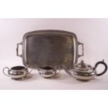 An Art Deco style pewter three piece tea set of low form, with spot hammered and bead decoration,