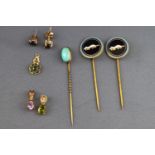 A collection of jewellery to include three stick pins, three pendants and ....