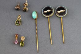 A collection of jewellery to include three stick pins, three pendants and ....