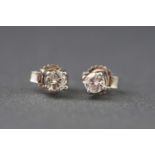 A white metal pair of single stone diamond stud earrings. Estimated total weight 0.20cts.