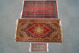 Three small rugs : A Berber design hand woven rug, decorated with lozenge motifs