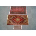 Three small rugs : A Berber design hand woven rug, decorated with lozenge motifs