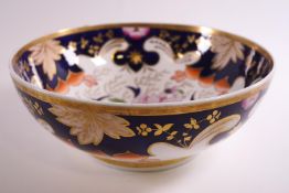A 19th century porcelain punch bowl, decorated in the Imari palette picked out in gilt,