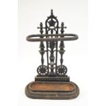 A cast iron umbrella stand with an anthemion back plate,