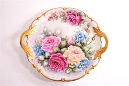 A Hutschenreuther two handled plate in the Rococo style, decorated with roses and forget me nots,