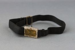 A white metal cocktail watch with black ribbon strap.