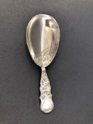 A silver caddy spoon with shaped bright cut engraved handle and similarly decorated tear drop bowl,
