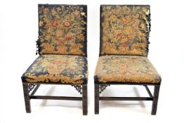 A pair of eighteenth century Chippendale style side chairs with tapestry back and seats on carved