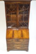 A George III style bureau bookcase, with two astragal glazed doors, above a fall front,