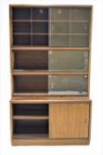 A pair of mahogany three tier book bookcases with sliding glass doors