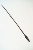 A tribal spear with hardwood shaft and metal blade end,