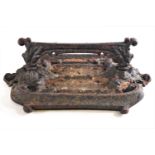 A cast iron boot scraper, of rectangular form with c scroll motifs,