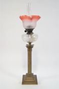 A 19th century oil lamp, with glass shade and chimney above a cut glass reservoir,