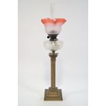 A 19th century oil lamp, with glass shade and chimney above a cut glass reservoir,