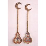 Two gilt Russian spoons with enamelled crescent finials over twisted stems set a pear shaped,